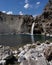 Impressive vertical photo of turquoise light blue waterfall located in the Cajon del Maipo, Andes Mountains called Salto el Yeso,