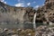 Impressive vertical photo of turquoise light blue waterfall located in the Cajon del Maipo, Andes Mountains called Salto el Yeso,