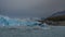 An impressive wall of blue ice with cracks and crevices.