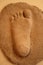 Imprint of the child foot in clay