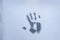 Imprint of a human palm on a frozen window glass inspires fear and horror