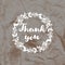 Imprint of the stamp Thank you on a crumpled kraft paper background.