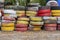 An impromptu fence made of old waste car tires, which are painted in different colors.