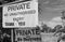 Improvised and polite Private sign seen attached to a rusted gate at an entrance to a paddock.