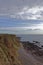 The inaccessible small Narrow shingle beach at Rumness with its Rocky outcrops exposed at Low Tide