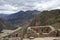 Inca ruins in Pisac archeological site and green peruvian Andes mountains, Sacred valley of the Incas, Peru