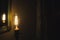 Incandescent bulb. Vintage hanging Edison light bulb in a dark, spooky room with curtains