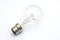 Incandescent tungsten clear B22 bayonet fitting light bulb on white
