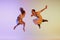 Incendiary dance. Emotional couple of dancers in retro style outfits dancing social dances isolated on gradient lilac