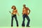 Incendiary dance. Emotional man and woman in retro style clothes dancing disco dance over green background. Concept of