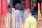 Incense joss stick burning slowly with fragrant smell smoke. People praying on Chinese Buddhist temple on Chinese new year, Luna n