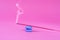 Incense red stick smoke on blue rock on pink