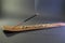 Incense with smoke in a small wooden table. Black background isolated