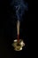 Incense sticks are burning in incense pot on the black background. The smoke during incense sticks burning for make merit.