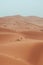 Incidental local berber man wandering through Sahara Desert Merzouga, Morocco