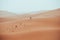 Incidental local berber man wandering through Sahara Desert Merzouga, Morocco