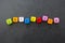 Inclusion text of multi colored cubes on dark background. Inclusive social concept