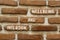 Inclusion and wellbeing symbol. Concept words Inclusion and wellbeing on beautiful brown brick. Beautiful red brown brickwall