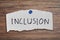 Inclusion word written on torn paper.