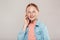 Inclusive Beauty. Girl with freckles in denim jacket standing isolated on grey talking on phone smiling cheerful