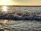 Incoming ocean waves and sunlight reflections from the sand beach at Agadir, Morocco, Africa at sunset