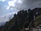 An incomparable panoramic view of forests, mountains and conifer trees with clouds in blue sky