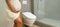 Incontinence and frequent urination during pregnancy. Pregnant woman need to pee standing by toilet in bathroom