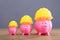 Increasing Pink Piggy Banks With Yellow Hard Hat