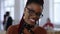 Incredible close-up portrait of young happy African creative business woman in smart eyeglasses smiling at modern office