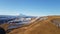 Incredible landscape with mount Elbrus. Autumn time. Desert terrain with dried grass and snow
