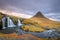 Incredible Nature landscape of Iceland. Fantastic picturesque sunset over Majestic Kirkjufell (Church mountain) and waterfalls.