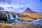 Incredible Nature landscape of Iceland. Fantastic picturesque sunset over Majestic Kirkjufell (Church mountain) and waterfalls.