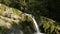 Incredible nature. Waterfall in the mountains. Flowing clear water from a waterfall and large river stones