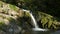 Incredible nature. Waterfall in the mountains. Flowing clear water from a waterfall and large river stones