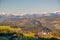 Incredible scenic view of traditional tyrol village with church in alpine valley at autumn sunny day