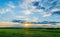 Incredible stunning sunset with a colorful sky against the background of green vegetation of wild nature