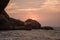 Incredible sunset overlooking rocks in India on Agonda beach, Go