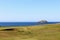 An incredible view of a golf hole in Scotland with the ocean in the background