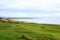 An incredible view of a golf hole in Scotland with the ocean in the background in Dornoch