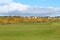 An incredible view of a golf hole in Scotland with the ocean in the background in Dornoch