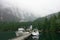 An incredible view of princess louisa inlet and chatterbox falls from the dock with boats tied up, in British Columbia, Canada.