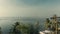 Incredible views of the bay where the boat floats. Frame rises above palm trees with coconuts in the afternoon