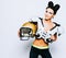 An incredibly beautiful, athletic brunette girl in a shoulderpads and an American football helmet demonstrating stunning