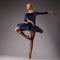 Incredibly beautiful ballerina in blue outfit dancing in studio. classical ballet art.