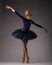 Incredibly beautiful ballerina in blue outfit posing and dancing