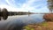 Incredibly peaceful clean water lake surrounded by pine birch trees and scenic beauty under the cloud