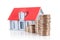 Incremental dollar coins and small house models on a white background