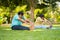 Indain senior couple at morning doing yoga at park - concept of healthy active lifestyle, outdoor fitness and wellness