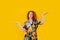 Indecisive redhead woman making i don`t know gesture over yellow