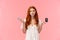 Indecisive and unsure cute european redhead woman shrugging, looking confused and useless camera, shrugging with